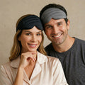 Man and woman wearing sleep masks against a beige background