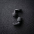 earplugs side view on dark surface 