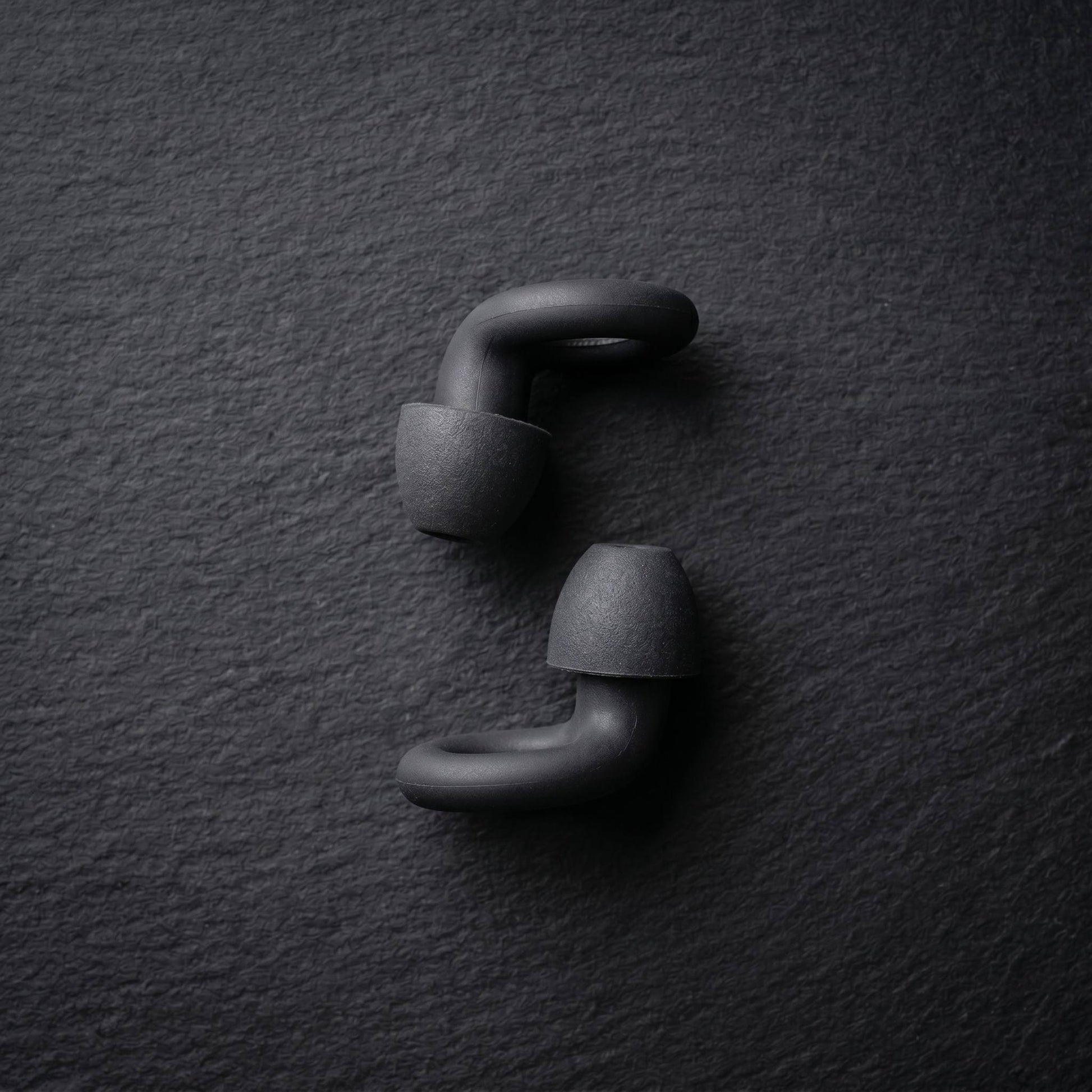 earplugs side view on dark surface 