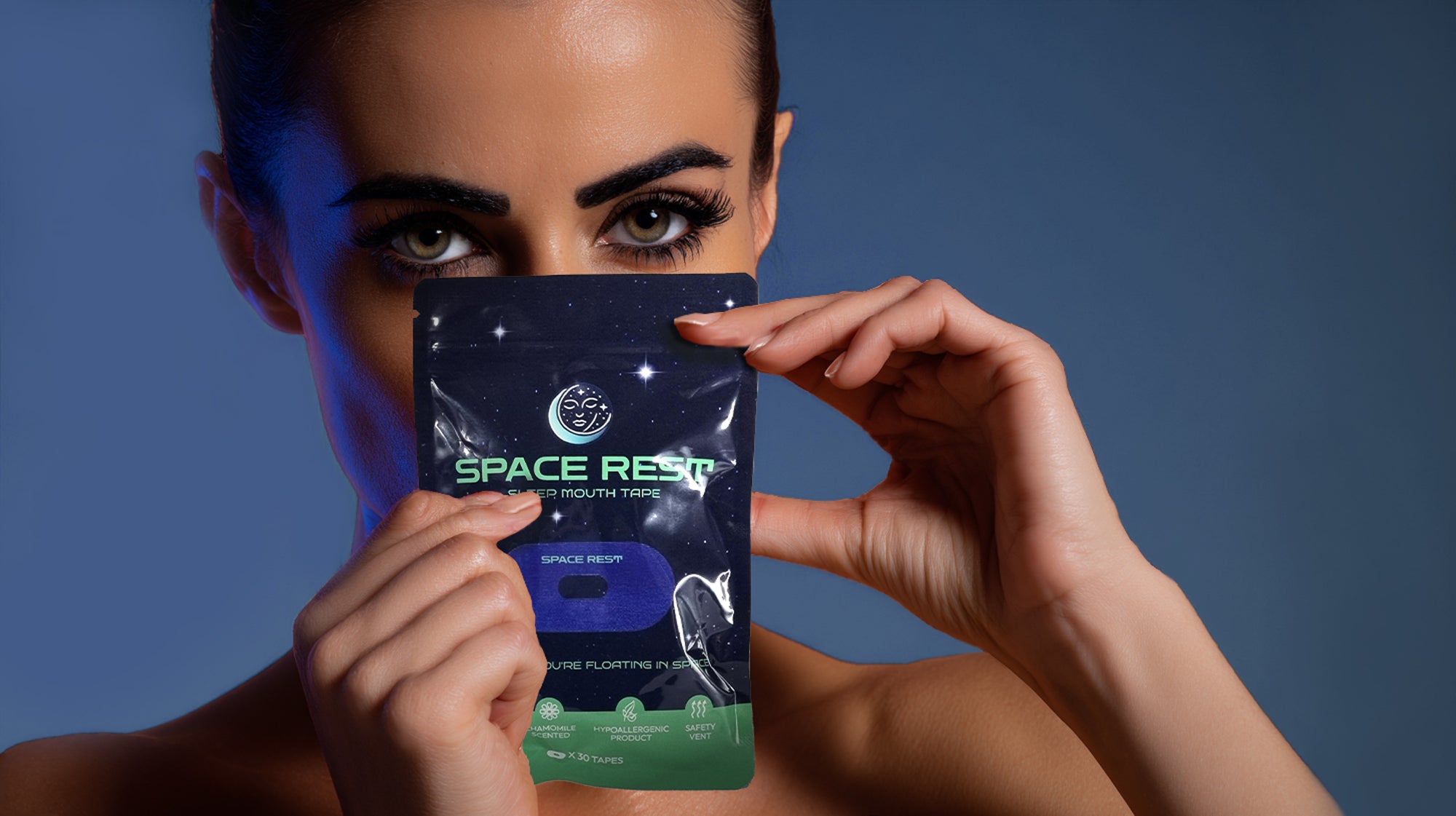 Person holding a 'Space Rest' product package against a blue background